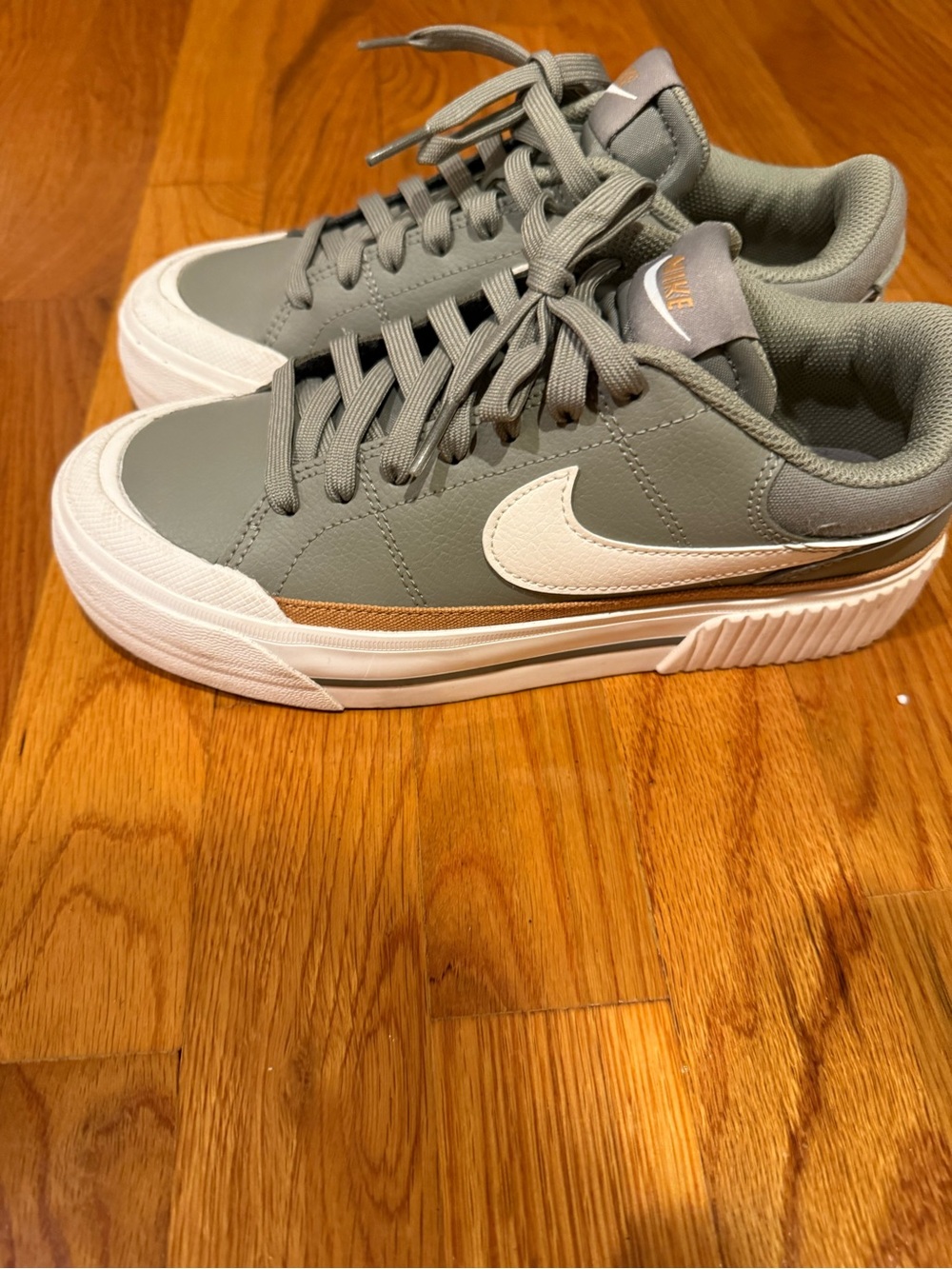 Nike Women's Green Sneakers with White Swoosh and Gold Accent
